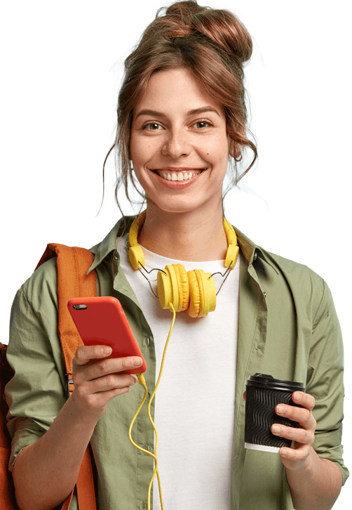 A girl smiling, holding a coffee and her phone.
